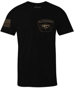 A black short-sleeve t-shirt with a tan/gold 'ALLEGIANCE' winged emblem printed on the left chest and a tan/gold American flag graphic on the right sleeve, shown against a plain white background.
